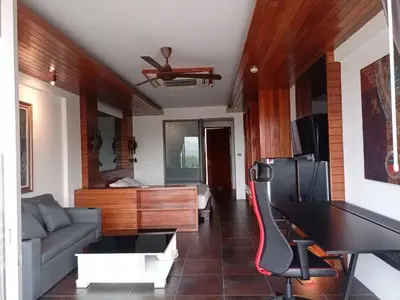 a living room with a couch and a piano at The green golf resident in Kathu