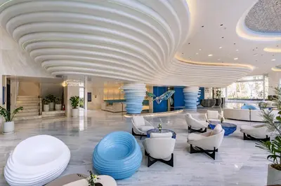 a lobby of a hotel with a large ceiling at Kora Beach Resort Phuket in Bang Tao Beach