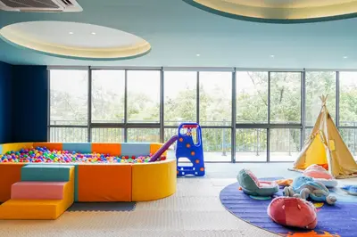 a childs play room with toys and a tent at Kora Beach Resort Phuket in Bang Tao Beach