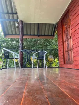 a patio with two chairs and a table on a porch at thechalethome in Panwa Beach