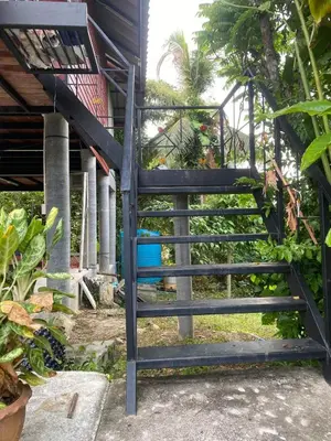 a set of stairs leading up to a house at thechalethome in Panwa Beach