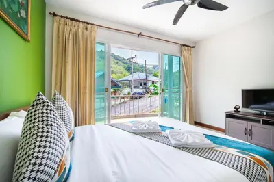 a bedroom with a bed and a large window at \u82ad\u4e1cvilla3\u56db\u5367\u6d77\u666f\u6cf3\u6c60\u522b\u5885\u82ad\u4e1c\u6d77\u6ee9\u8fd1\u73ed\u8d5eBangla in Patong Beach