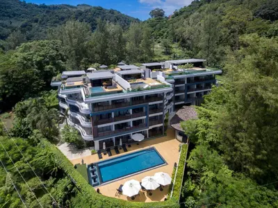 an aerial view of a building with a swimming pool at Nakalay Palm by Thaire in Kamala Beach