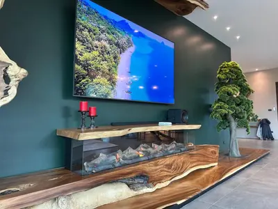 a living room with a fireplace with a flat screen tv at Karon Beach Residence in Karon Beach