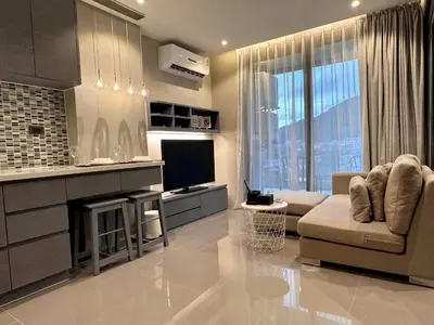 a living room with a couch and a television at Junior Suite D37 Kamala Beach in Kamala Beach