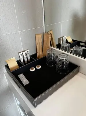 a counter with a mirror and a pile of plates at Aristo Resort M08 Surin Beach in Surin Beach