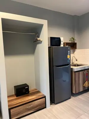 a kitchen with a refrigerator and a microwave at Afiyath Residence in Kamala Beach