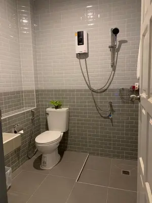 a bathroom with a toilet and a shower in it at Afiyath Residence in Kamala Beach