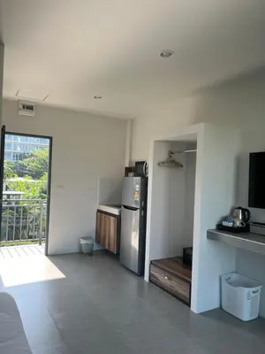a kitchen with a stainless steel refrigerator in a room at Afiyath Residence in Kamala Beach