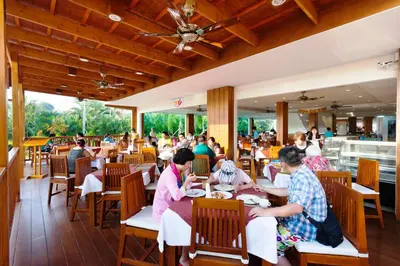 a group of people sitting in a restaurant at Rawai Princess Hotel in Rawai Beach