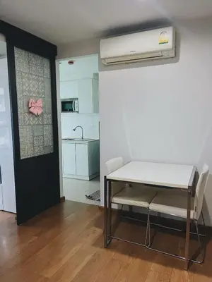 a room with a table and chairs and a kitchen at 38Nice room phuket town near Shopping Malls and Naka night market in Phuket Town