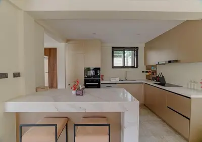 a large kitchen with a large white counter top at ANDAMAN Villa KOH YAO NOI in Ko Yao Noi