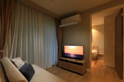 a living room with a flat screen tv in a room at Apartment 2 BDR Bangtao #2206 in Phuket