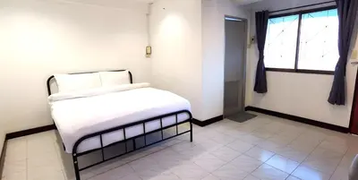 a bedroom with a white bed and a window at XX GO INN Patong Beach หาดป่าตอง in Patong Beach