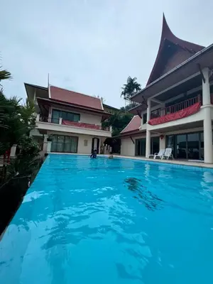 a swimming pool in front of a house at Kata Sea Cloud Villa\u534a\u5c71\u6d77\u666f\u72ec\u680b\u522b\u5885 in Kata Beach