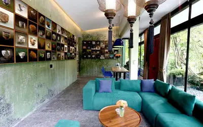 a living room with a blue couch and a table at Seava House Ao-Nang Krabi in Ao Nang Beach