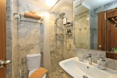 a bathroom with a toilet and a sink and a shower at Studio 777 condo MaiKhao in Phuket Town