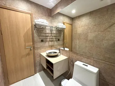 a bathroom with a toilet and a sink and a mirror at Private apartment Title V Condo by Lofty in Rawai Beach