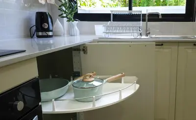a kitchen counter with bowls on a shelf next to a sink at Calm & Cozy Vacation House in Rawai Beach