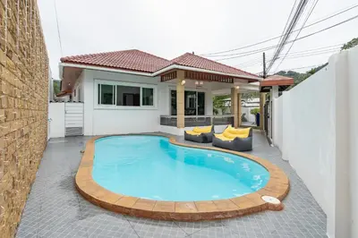 a swimming pool in front of a house at Pool Villa 3 Bedrooms, Closeby Patong, Chic and Quiet in Kathu