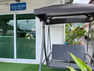 a table and a bench in front of a building at Yada House Alina Cottage in Nai Yang Beach