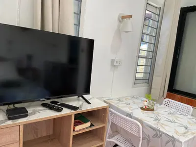 a large flat screen tv sitting on top of a table at Yada House Alina Cottage in Nai Yang Beach