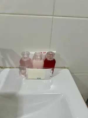 two bottles of milk sitting on top of a toilet at Karon Butterfly Residence in Kata Beach