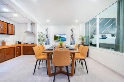 a kitchen and dining room with a table and chairs at Cozystay Center of Patong near Bangla Road in Patong Beach