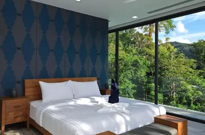 a bedroom with a bed with a large window at 4BDR Sugar Villa 2 in Kamala Beach