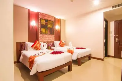 a hotel room with two beds in a room at Patong Hemingways Hotel in Patong Beach