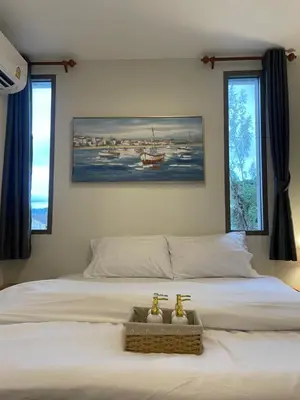 a bedroom with a bed with two faucets on it at Sunny Balcony in Ban Khlong Haeng