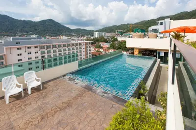 a swimming pool on the roof of a building at Hemingways Silk Hotel in Patong Beach