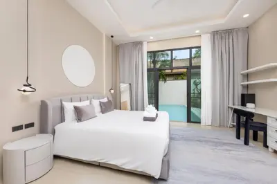 a bedroom with a white bed and a desk at VILLA Hinako Private Pool Nai Harn Beach in Rawai Beach