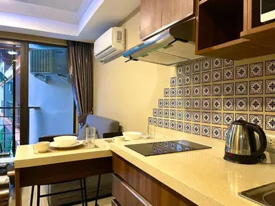 a kitchen with a stove and a counter top at Nai Harn Condominium in Rawai Beach