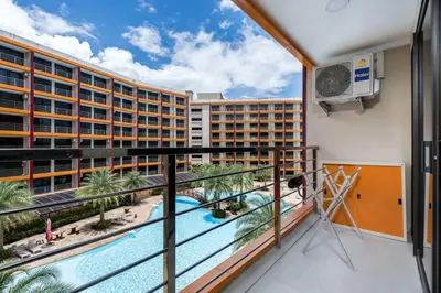 a balcony with a view of a resort at 1 BR apartment 777 Beach Condotel in Mai Khao Beach