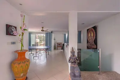 a living room with a table and a vase at Kamala Heights Villa in Kamala Beach