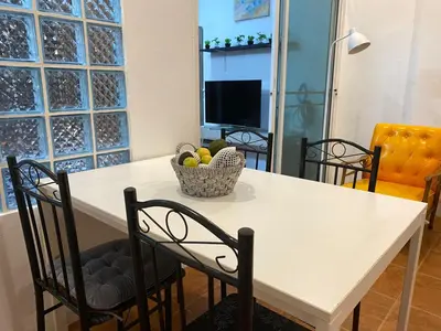 a table with chairs and a bowl of fruit on it at Bestin Karon 1 - Apartment GF- 1 min from Karon beach in Karon Beach