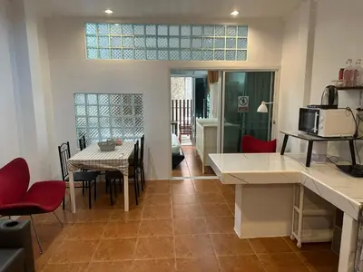 a kitchen and dining room with a table and chairs at Bestin Karon 1 - Apartment GF- 1 min from Karon beach in Karon Beach