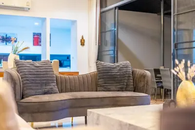 a living room with two couches and a table at High End Imported Furniture Loch Palm Golf Course V145 in Kathu