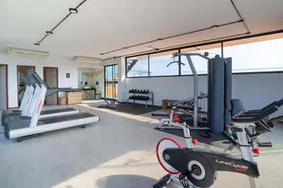 a gym with two tread machines and a treadmill at The Blue Mavi Hotel in Chalong