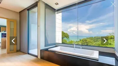 a bathroom with a tub and a large window at Ocean Heart 5BDR Seaview LUX villa in Ban Bang La