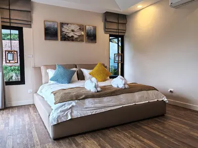 two dogs sitting on a bed in a bedroom at modern hill villa \u5c71\u95f4\u89c2\u6d77\u79c1\u4eba\u522b\u5885 in Patong Beach