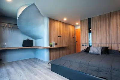 a bedroom with a bed and wooden walls at Three Double U - Kalim Sea View in Patong Beach