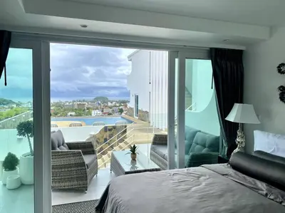 a bedroom with a bed and a balcony with a view at Kata Ocean View 1 bedroom 50 m2 in Kata Beach