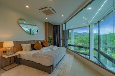 a bedroom with a bed and a large window at Luxury Golfside Villa near Patong - Villa Priva in Kathu