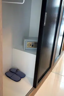 a bathroom with two blue towels on a shelf at Buasri By Ohm in Patong Beach