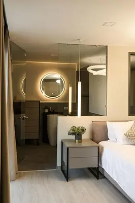 a bedroom with a bed and a table and a mirror at Brand New Luxury 3BR with Private Hammam in Chalong