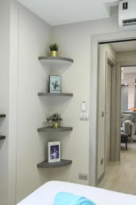 a room with shelves on the wall with a bed at Brand New Luxury 3BR with Private Hammam in Chalong