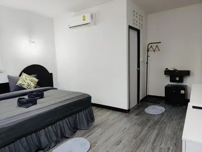 a bedroom with a large bed and a table at White House in Phi Phi Don