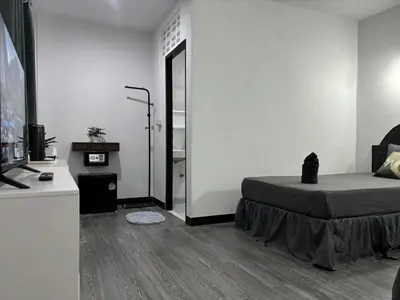a white room with a bed and a mirror at White House in Phi Phi Don